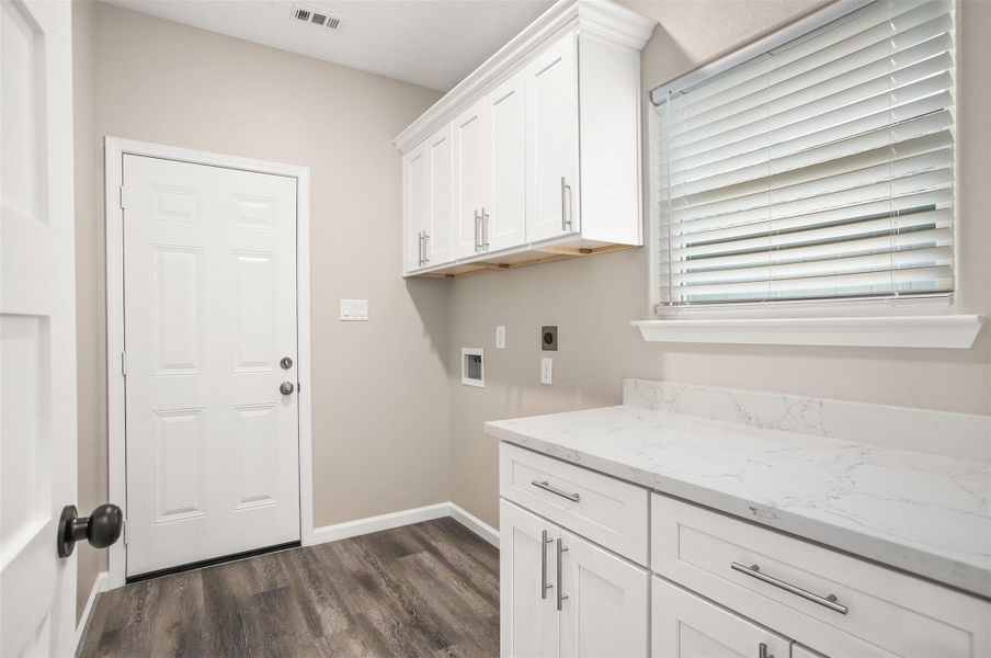 Laundry room with folding area and storage