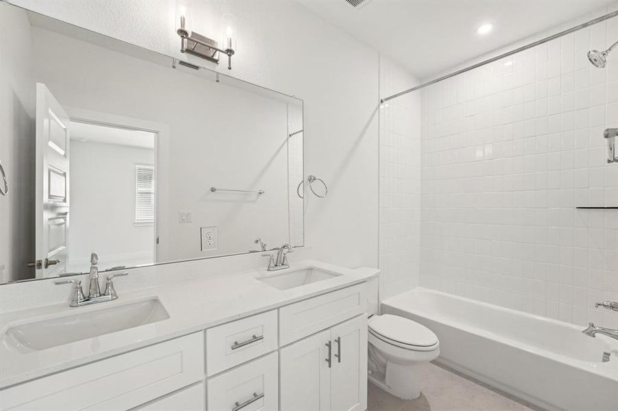 This ensuite features dual quartz vanities and a shower/tub combo. (Sample photo of finishes and layout)