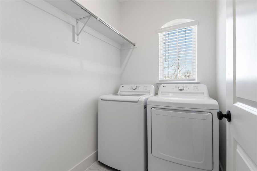 The Dedicated Laundry Room is Tucked Away Near the Garage