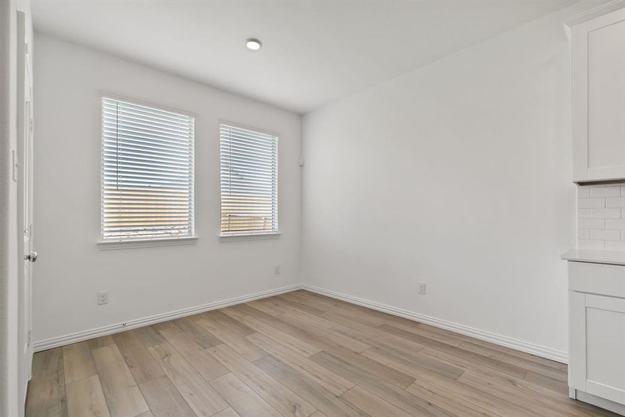 Spare room featuring light wood-type flooring