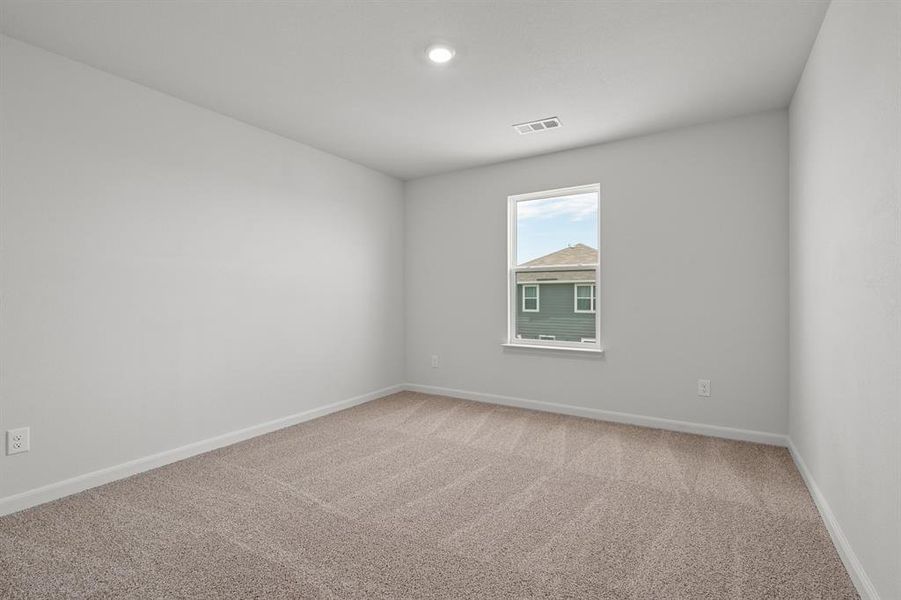 Empty room featuring light carpet and baseboards Empty room featuring light carpet and baseboards