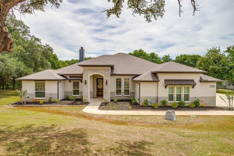Front exterior of a new home in , Poolville, TX, highlighting curb appeal (Image 2). Front exterior of a new home in , Poolville, TX, highlighting curb appeal (Image 2).