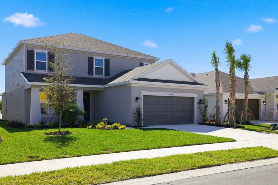 Front exterior of a new home in Firethorn, Parrish, FL, highlighting curb appeal (Image 1).