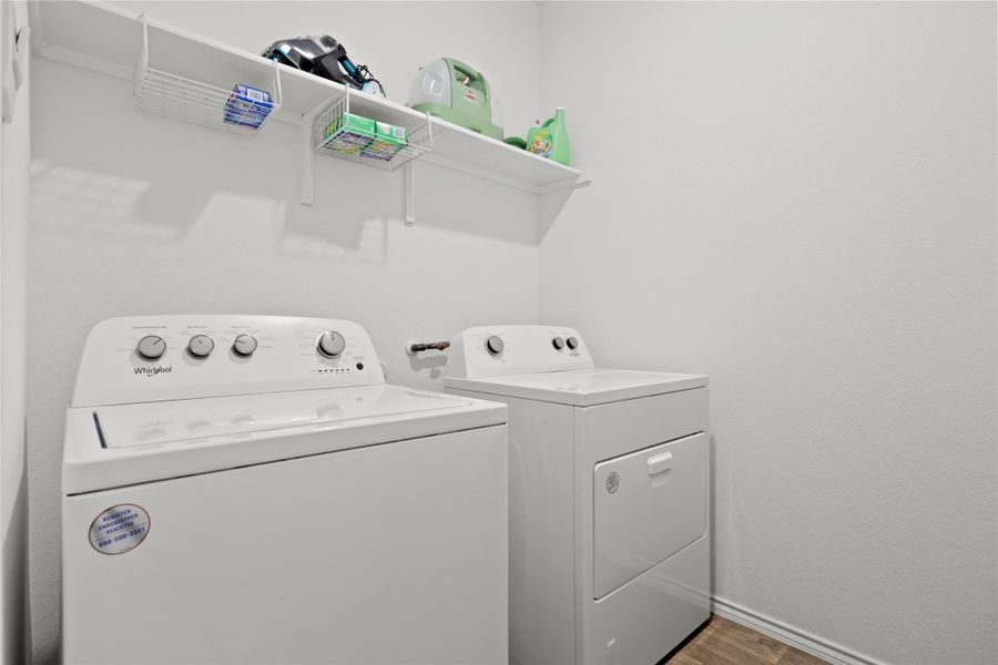 Laundry area with independent washer and dryer and dark wood-style floors