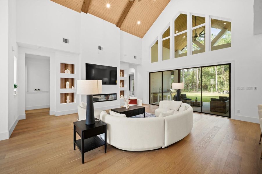Expansive windows frame beautiful wooded views while filling the home with natural light.