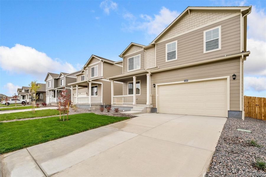Front exterior of a new home in Spring Valley Ranch, Elizabeth, CO, highlighting curb appeal (Image 2).