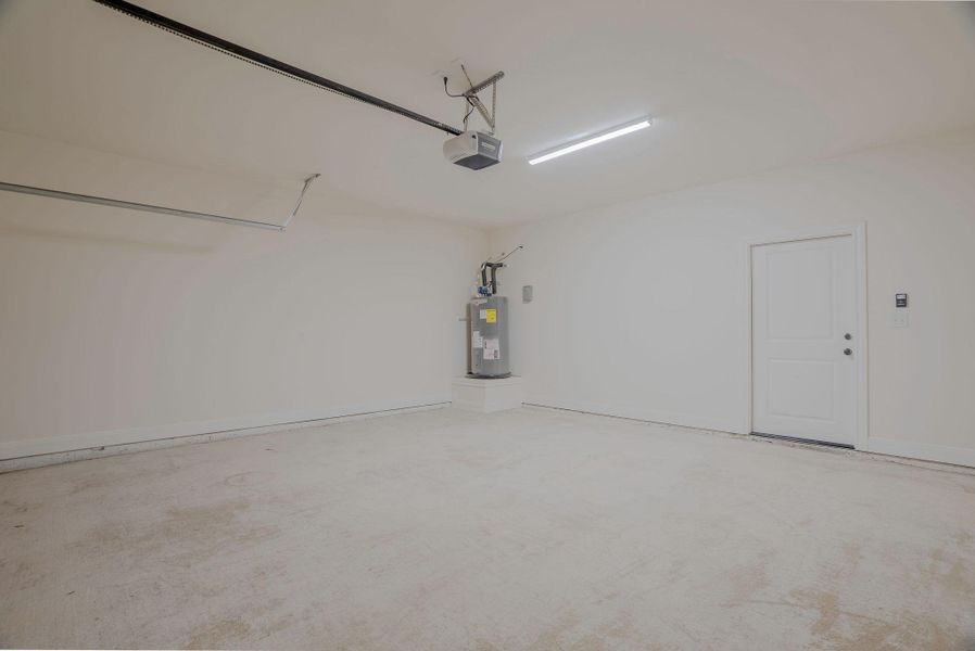 Garage with electric water heater and a garage door opener Garage with electric water heater and a garage door opener