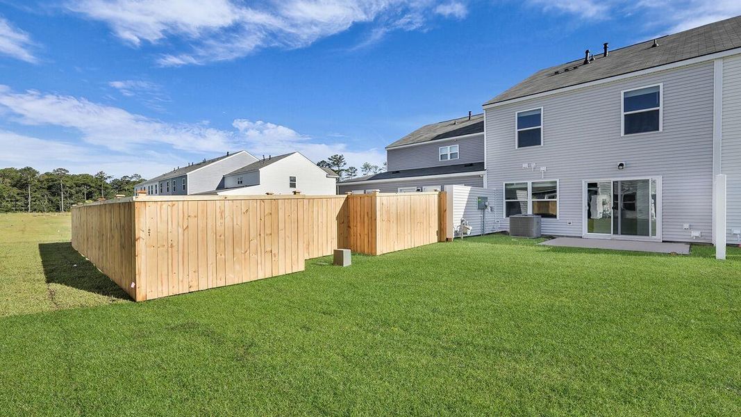 Exterior details and patio area of a home in Pine Hills Townhomes at Cane Bay, Summerville (Image 3).
