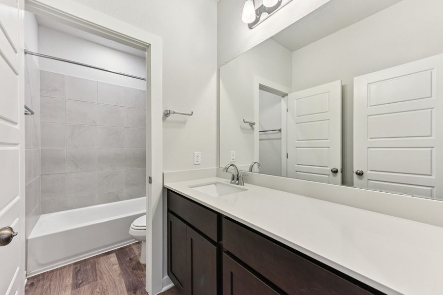 A bathroom with a tub and sink.