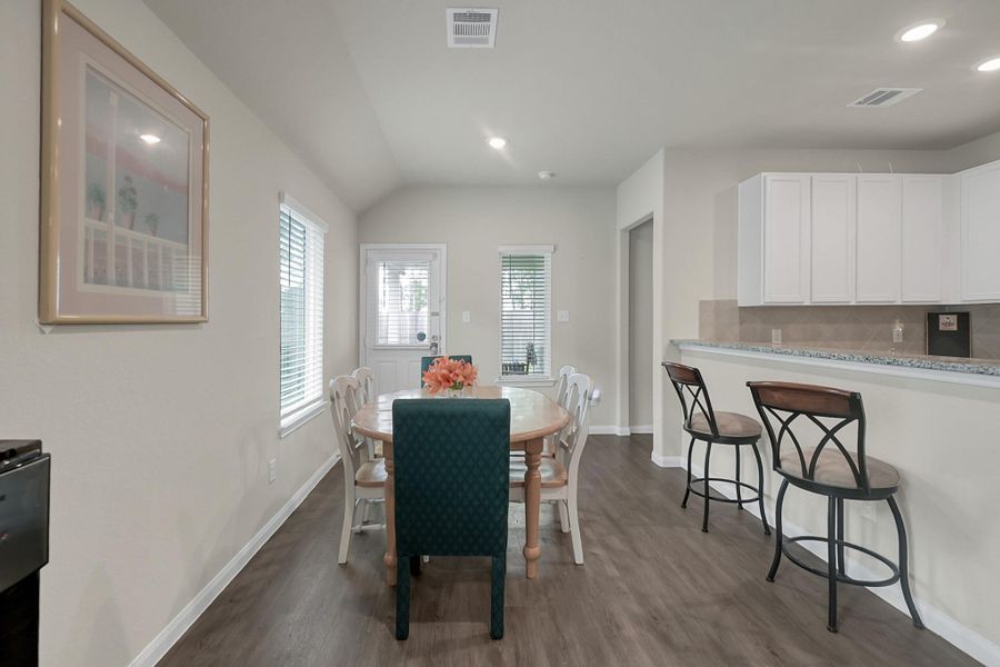 Dining room open to the kitchen and access to the back patio for entertaining.