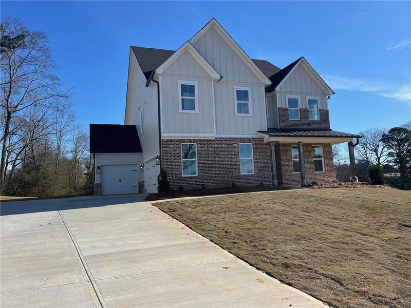 Front exterior of a new home in Acacia, Cumming, GA, highlighting curb appeal (Image 1).