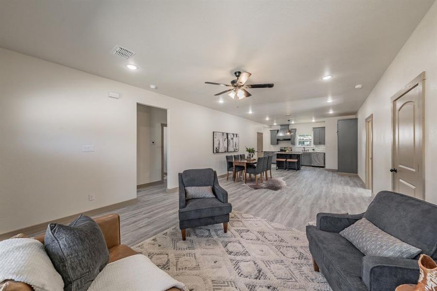 Living area featuring light wood-style flooring, recessed lighting, and a ceiling fan