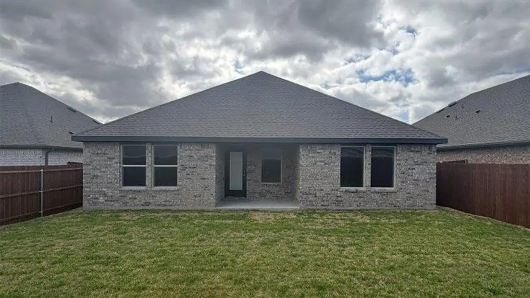 Back of house featuring brick siding, a patio area, and a fenced backyard Back of house featuring brick siding, a patio area, and a fenced backyard
