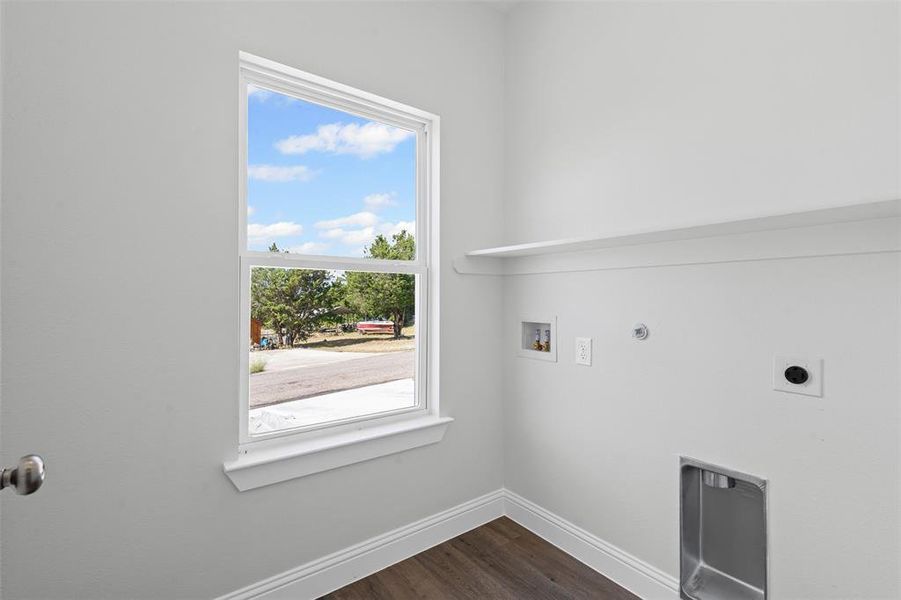 Washroom with dark wood-style floors, washer hookup, gas dryer hookup, and electric dryer hookup Washroom with dark wood-style floors, washer hookup, gas dryer hookup, and electric dryer hookup