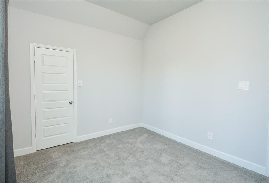 Inviting Primary Bedroom with Plush Carpeting and Ample Natural Light