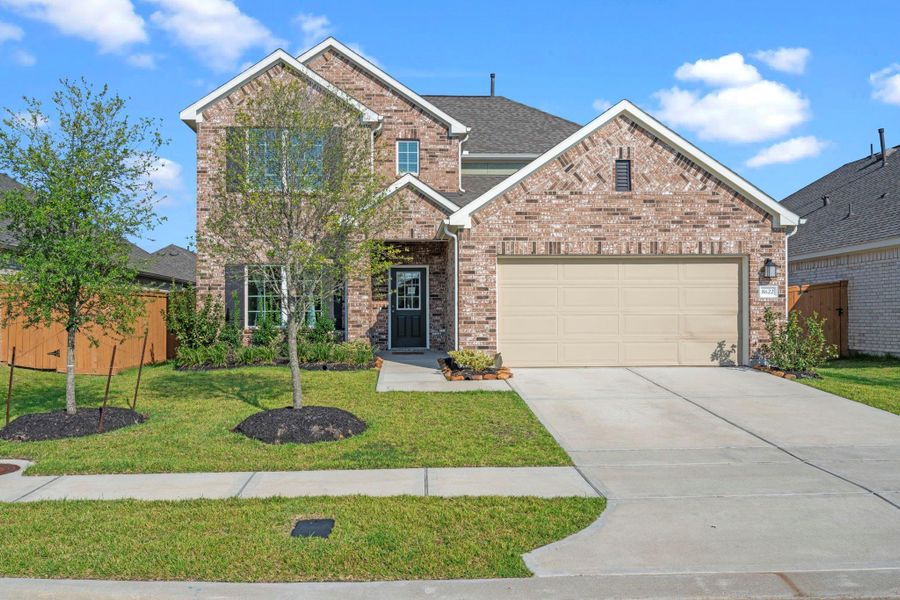 Front exterior of a new home in Marvida, Cypress, TX, highlighting curb appeal (Image 24). Front exterior of a new home in Marvida, Cypress, TX, highlighting curb appeal (Image 24).