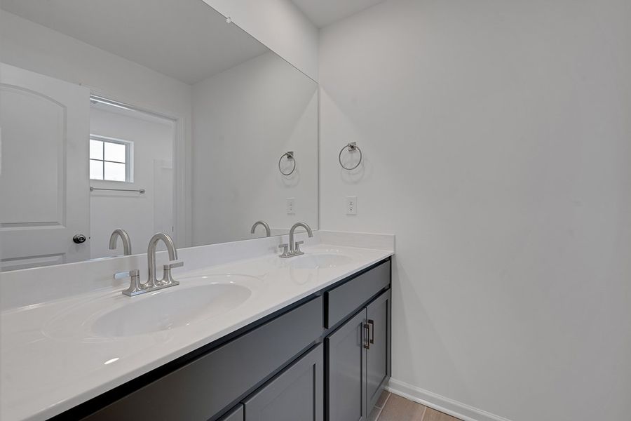 A bathroom with a large mirror.