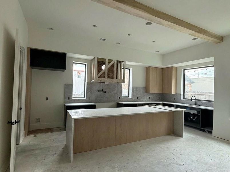 Kitchen- taking shape with abundant natural light. Finishes in progress. (Construction Photo as of 3/8/26 - Edited)