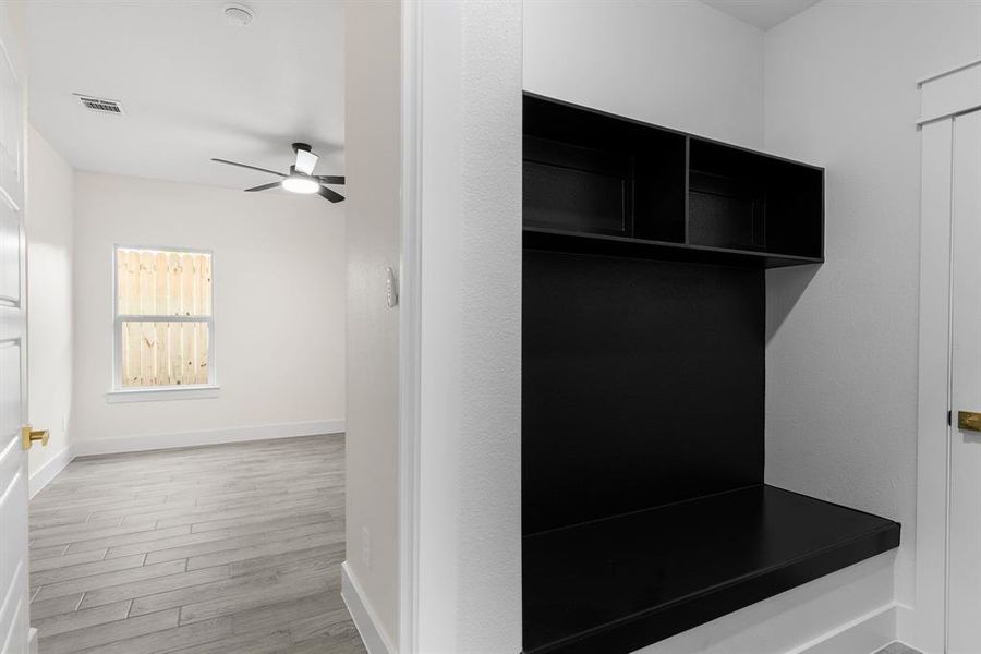 Mudroom featuring light wood-type flooring and ceiling fan