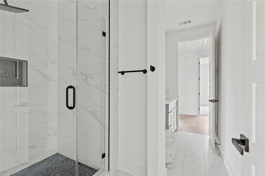Bathroom featuring marble finish floors, a marble finish shower, and vanity Bathroom featuring marble finish floors, a marble finish shower, and vanity
