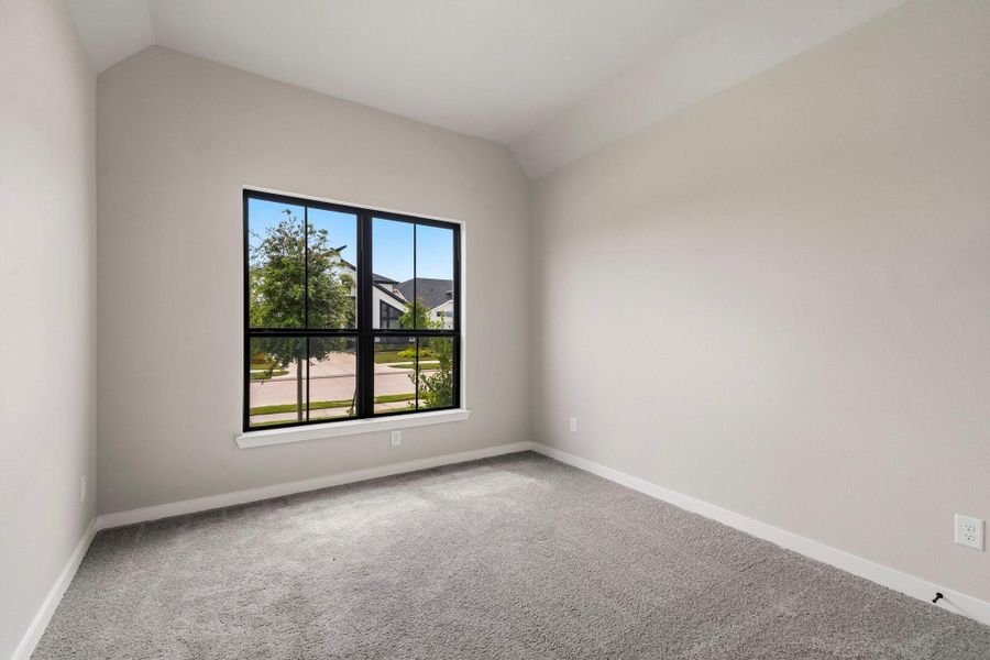 A secondary downstairs bedroom with lush upgraded carpets. A secondary downstairs bedroom with lush upgraded carpets.