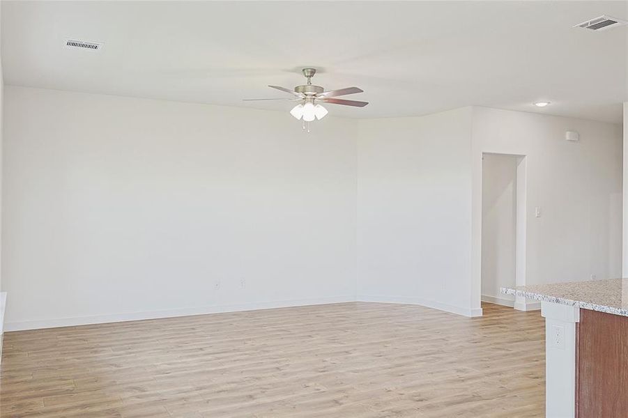 Unfurnished room with ceiling fan and light hardwood / wood-style flooring