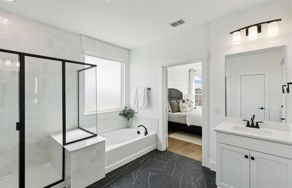 Luxurious owner's bath featuring dual vanities and a deep walk-in shower *Model representation Luxurious owner's bath featuring dual vanities and a deep walk-in shower *Model representation