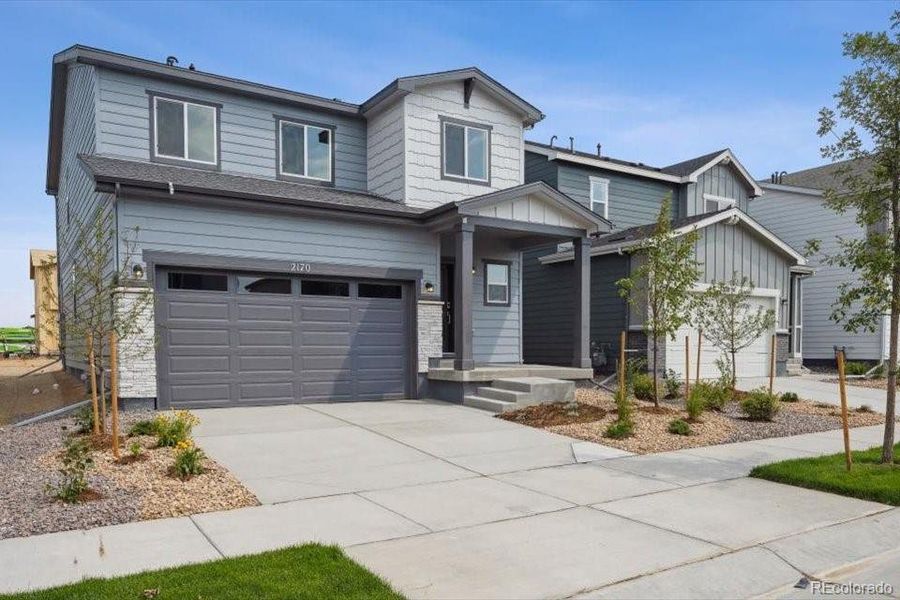 Front exterior of a new home in Farmlore, Brighton, CO, highlighting curb appeal (Image 15).