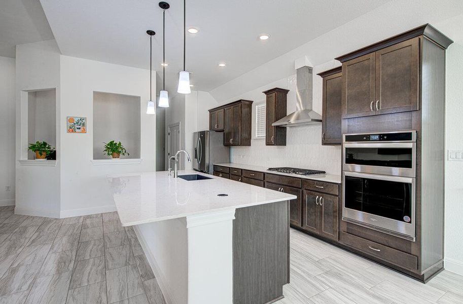 Rich wood cabinetry paired with light stone countertops creates an inviting culinary space. Rich wood cabinetry paired with light stone countertops creates an inviting culinary space.