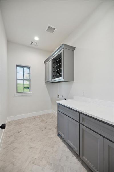 Washroom with cabinets and hookup for a washing machine