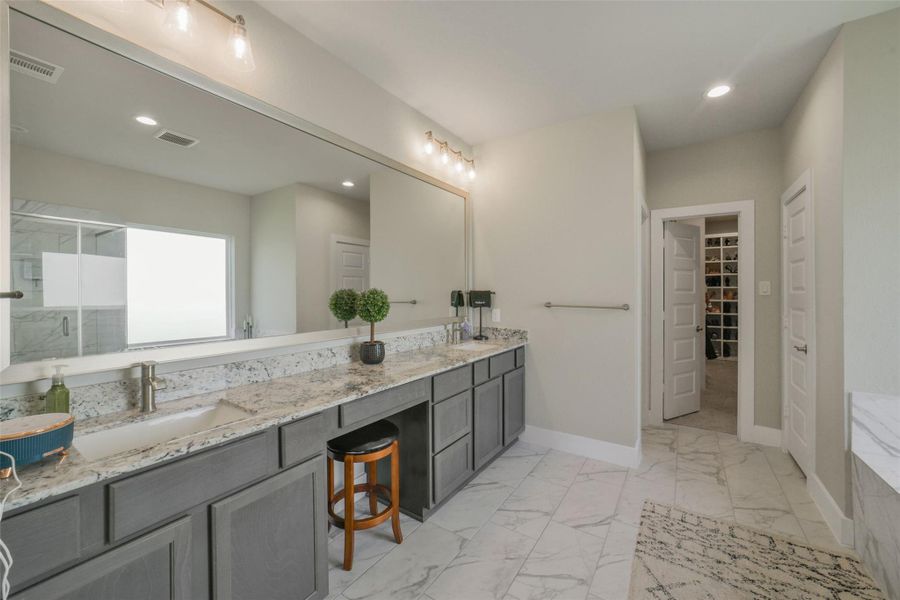 Spa inspired primary bathroom with dual vanities.