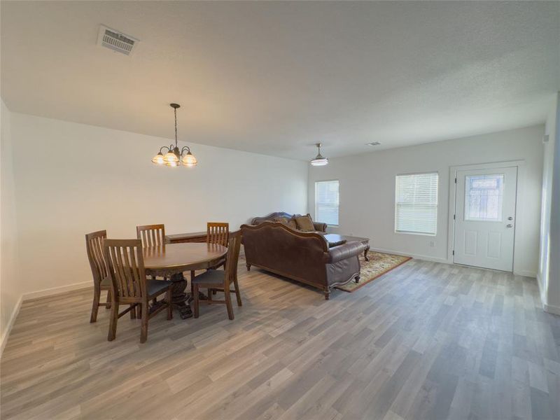 Dining space featuring wood-style floors and a chandelier