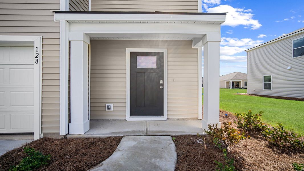Front exterior of a new home in Cobblestone Village, Savannah, GA, highlighting curb appeal (Image 2). Front exterior of a new home in Cobblestone Village, Savannah, GA, highlighting curb appeal (Image 2).