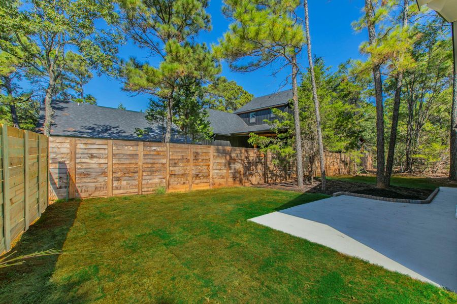 Fenced backyard featuring a patio