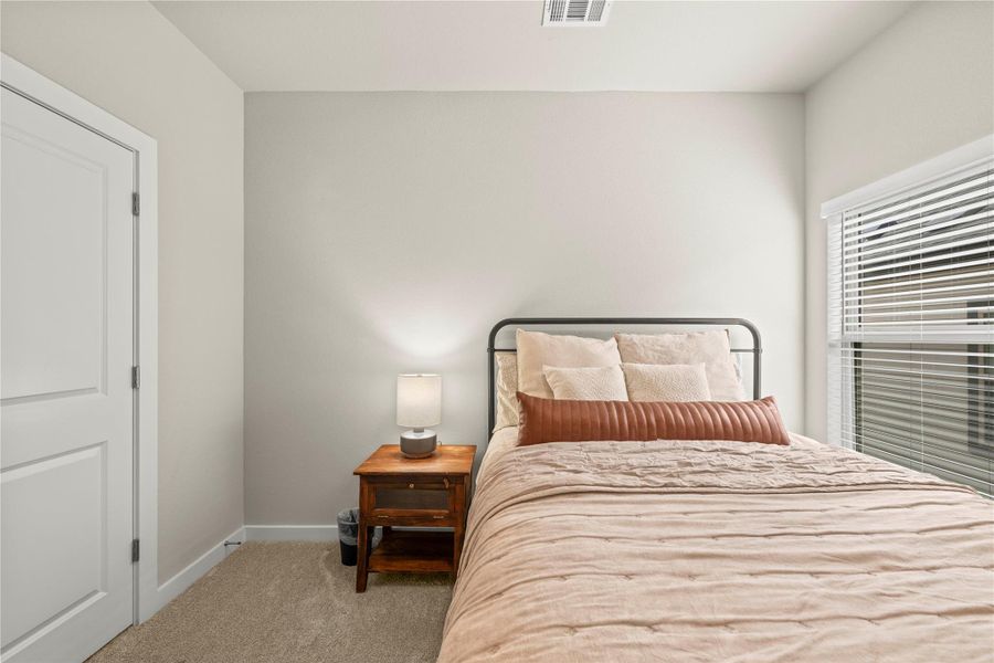 A quiet retreat, this bedroom offers carpeted flooring and abundant natural light through a generous window. A quiet retreat, this bedroom offers carpeted flooring and abundant natural light through a generous window.