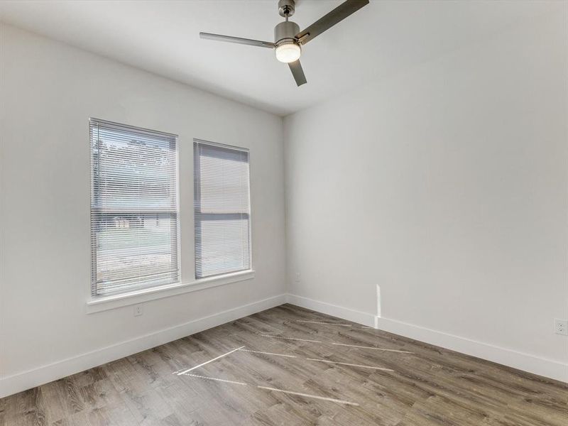 Spare room featuring wood finished floors and ceiling fan