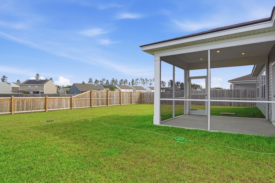 Exterior details and patio area of a home in Sanctuary Cove at Cane Bay, Summerville (Image 31).