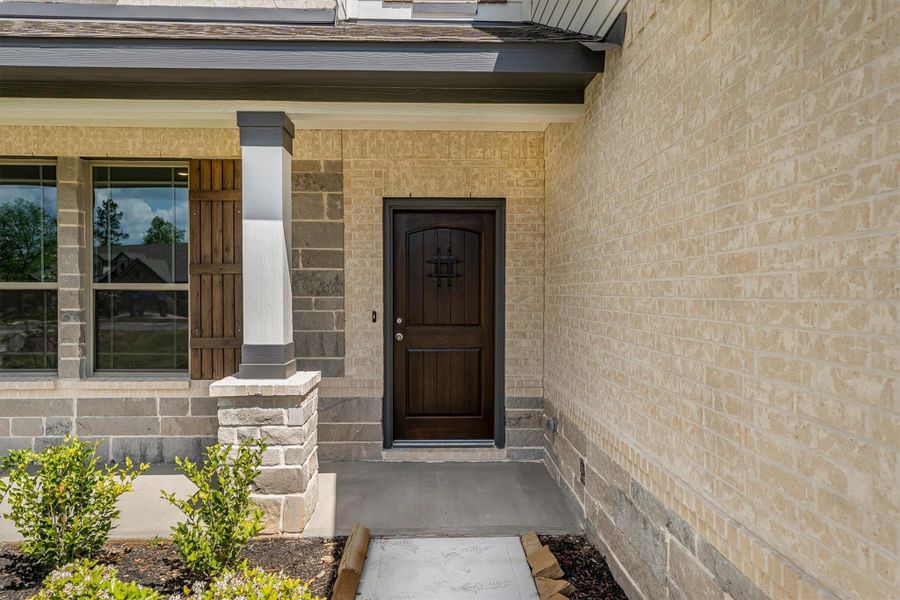 Inviting front porch and sold wood door welcome you home.