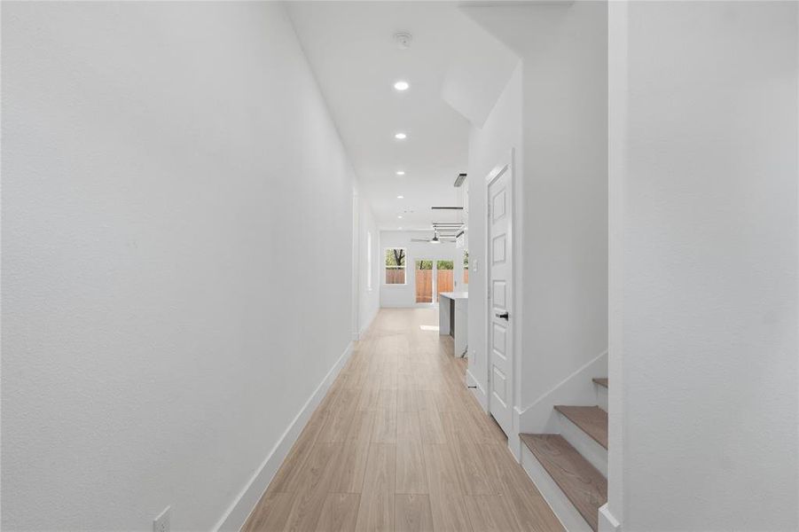 Corridor with light wood-type flooring and recessed lighting Corridor with light wood-type flooring and recessed lighting