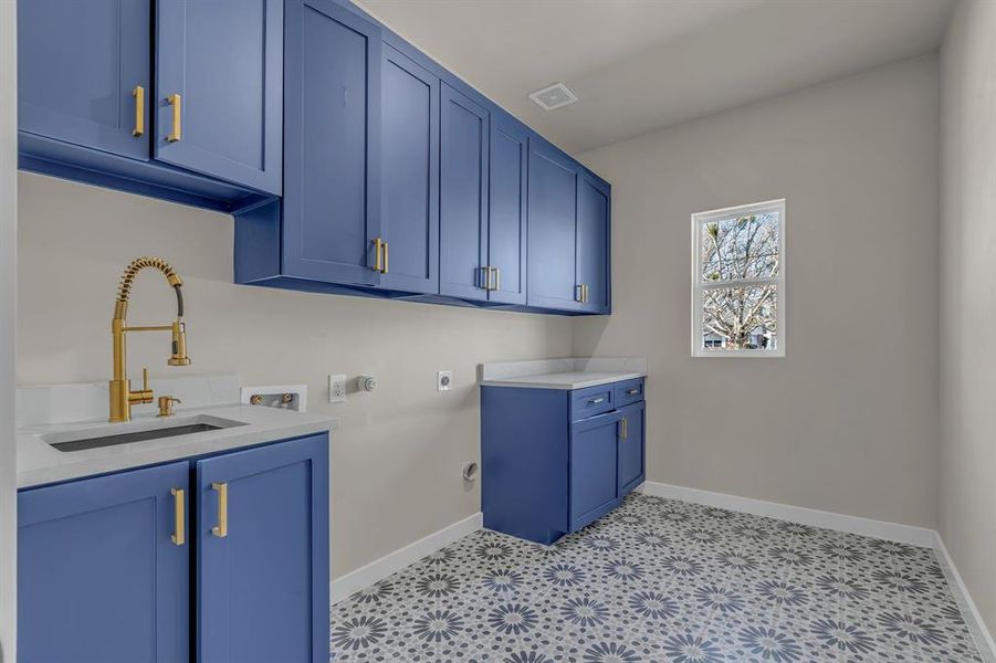 Laundry area with gas dryer hookup, sink, cabinets, washer hookup, and hookup for an electric dryer