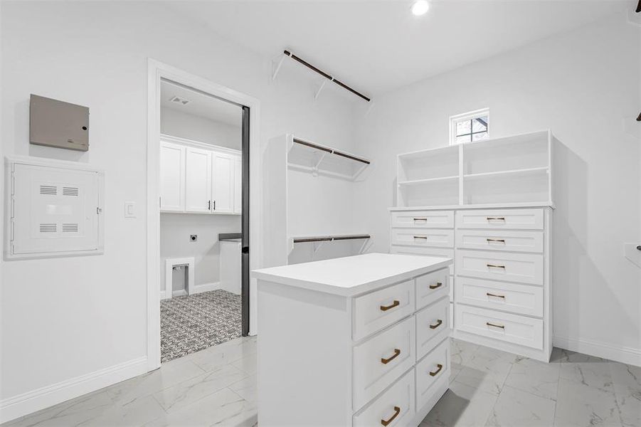 Spacious closet with light tile floors