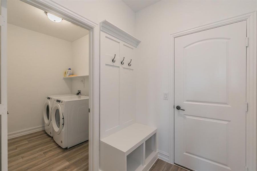 Mudroom featuring washer and dryer and dark wood-type flooring