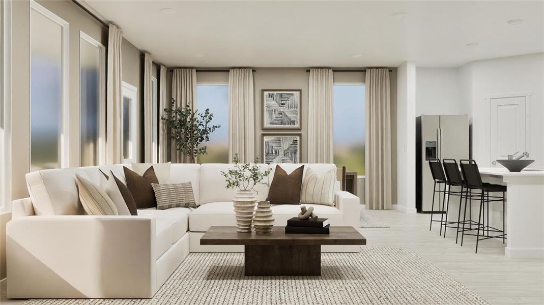 Living area featuring light wood-style floors and baseboards