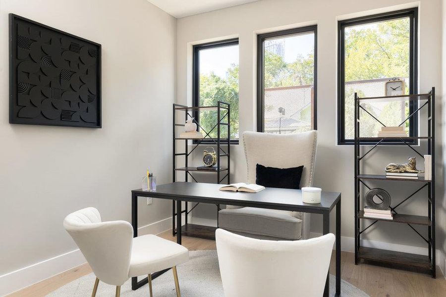 Office area featuring baseboards and light wood-style floors