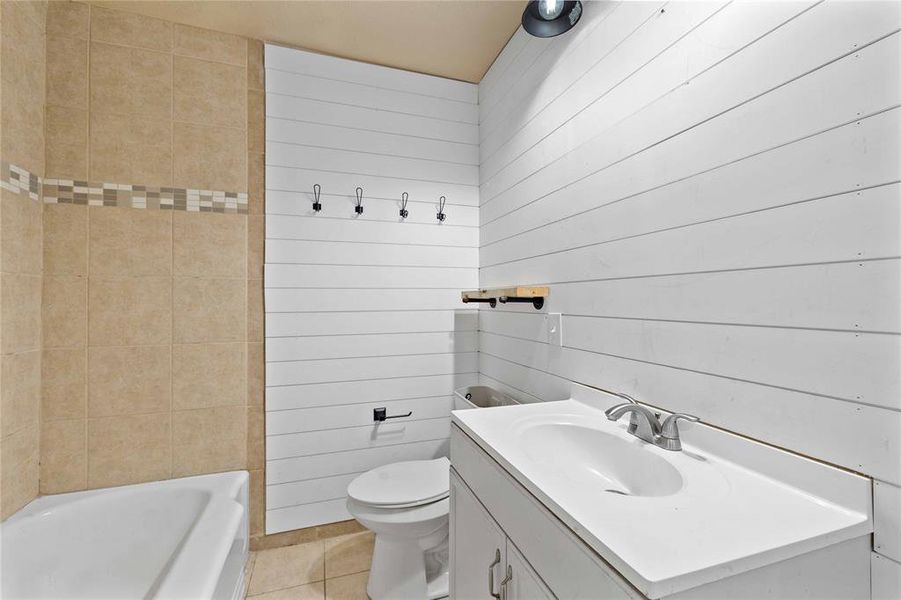 Bathroom with shiplap wall and tiled shower surround Bathroom with shiplap wall and tiled shower surround