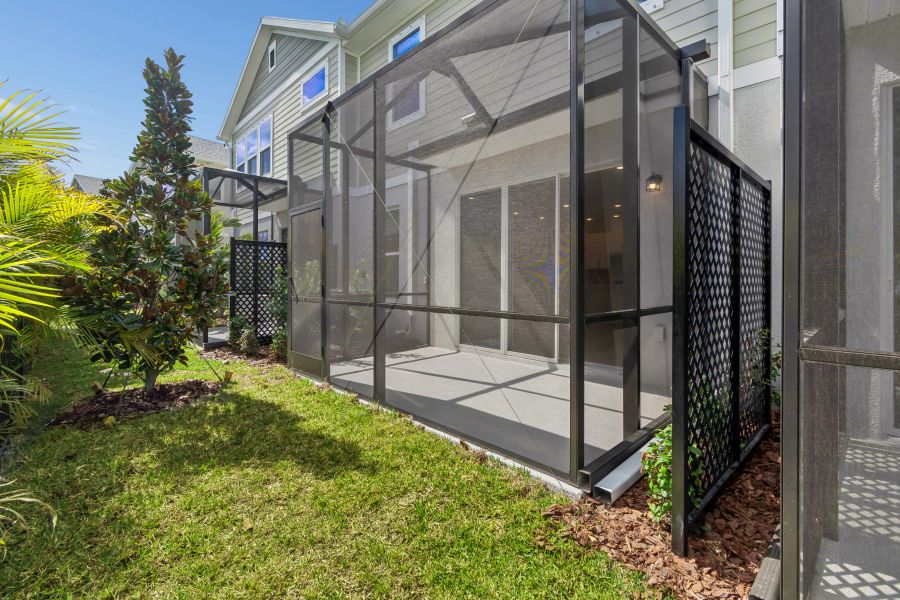 Exterior details and patio area of a home in North River Ranch – Townhomes, Parrish (Image 3).