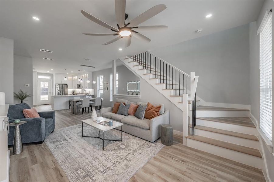 Living room featuring light hardwood / wood-style floors and ceiling fan