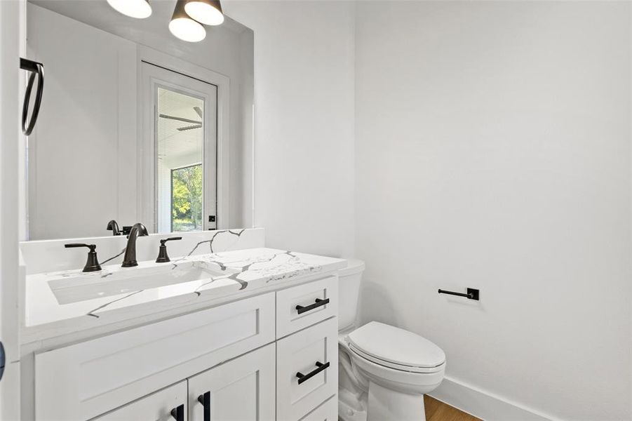 Half bathroom with vanity and wood finished floors Half bathroom with vanity and wood finished floors