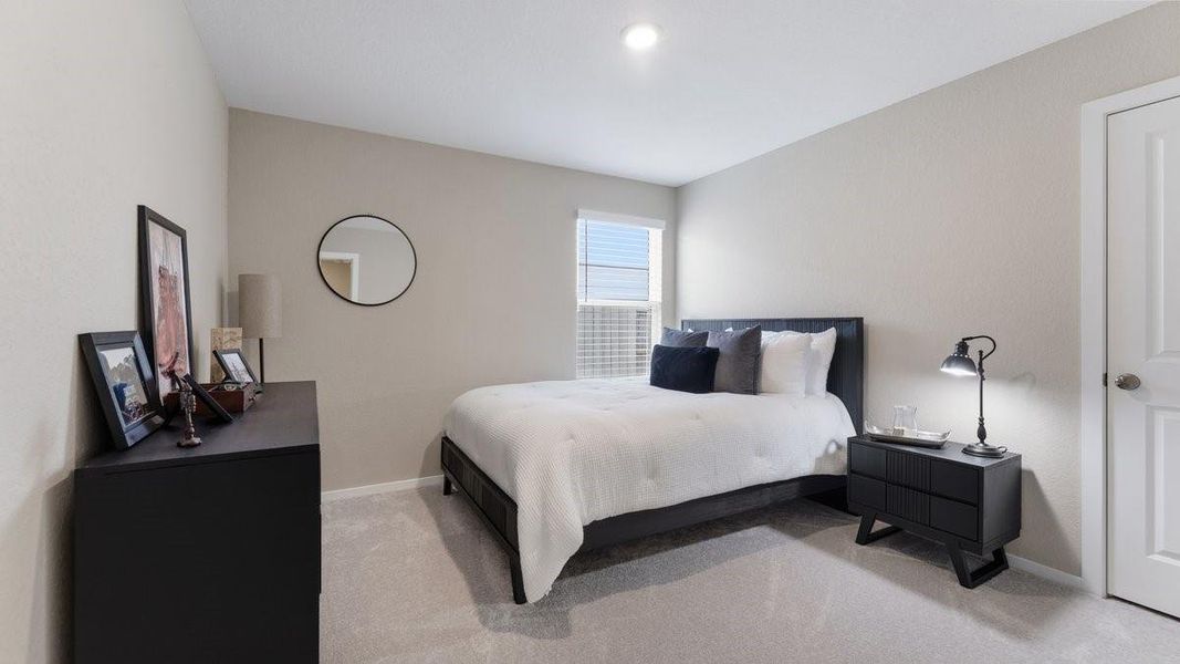 This photo shows a cozy bedroom with a modern design.