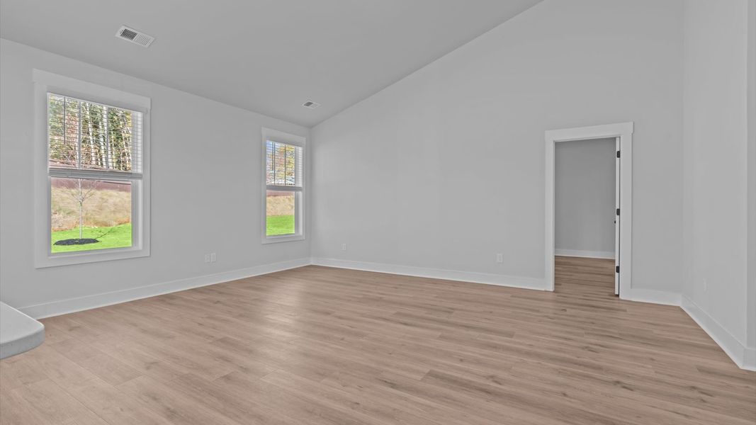 Refined and memorable, this family room features two-story ceilings and top-notch comfort throughout